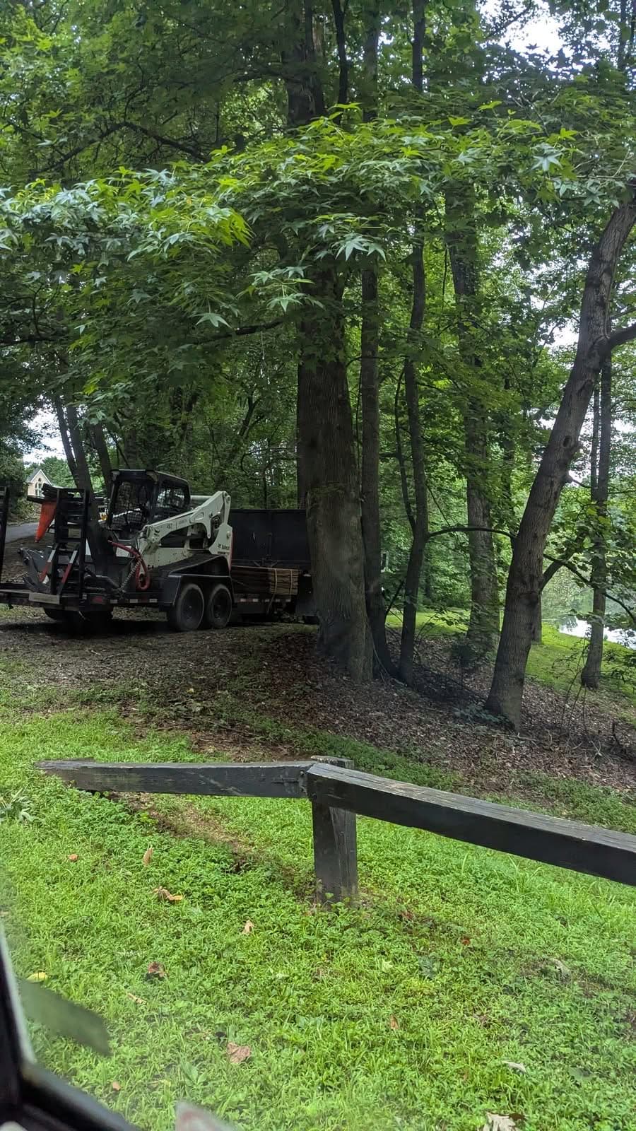Bobcat skid steer on an equipment trailer arriving for storm cleanup in Cumming GA, June 2025