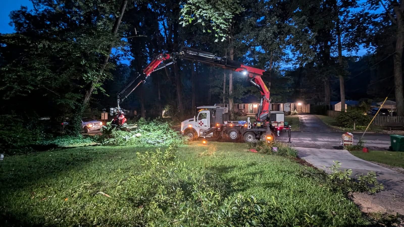 Tree-Mek grapple-saw crane truck working under lights at night in Decatur GA, July 2024