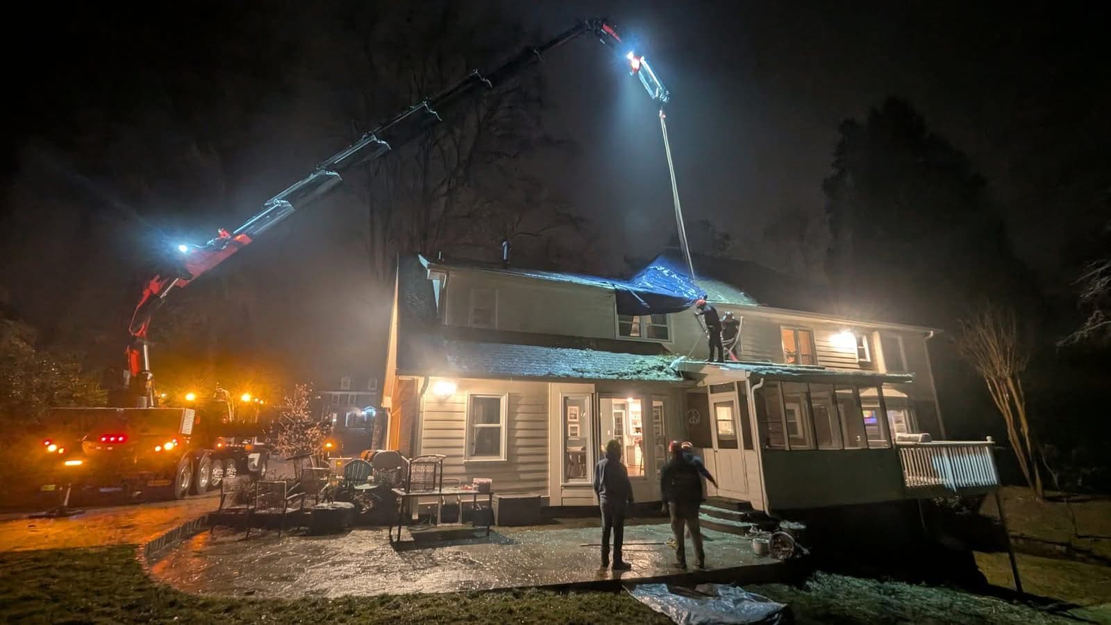 Roswell GA home at night with tree removed and roof tarped after emergency storm work, January 2026