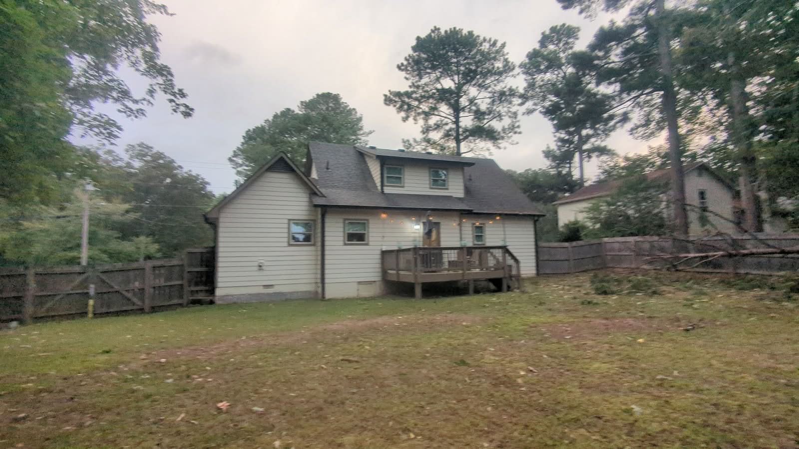 Backyard with storm-fallen pine on the fence line before removal in Kennesaw GA, September 2024