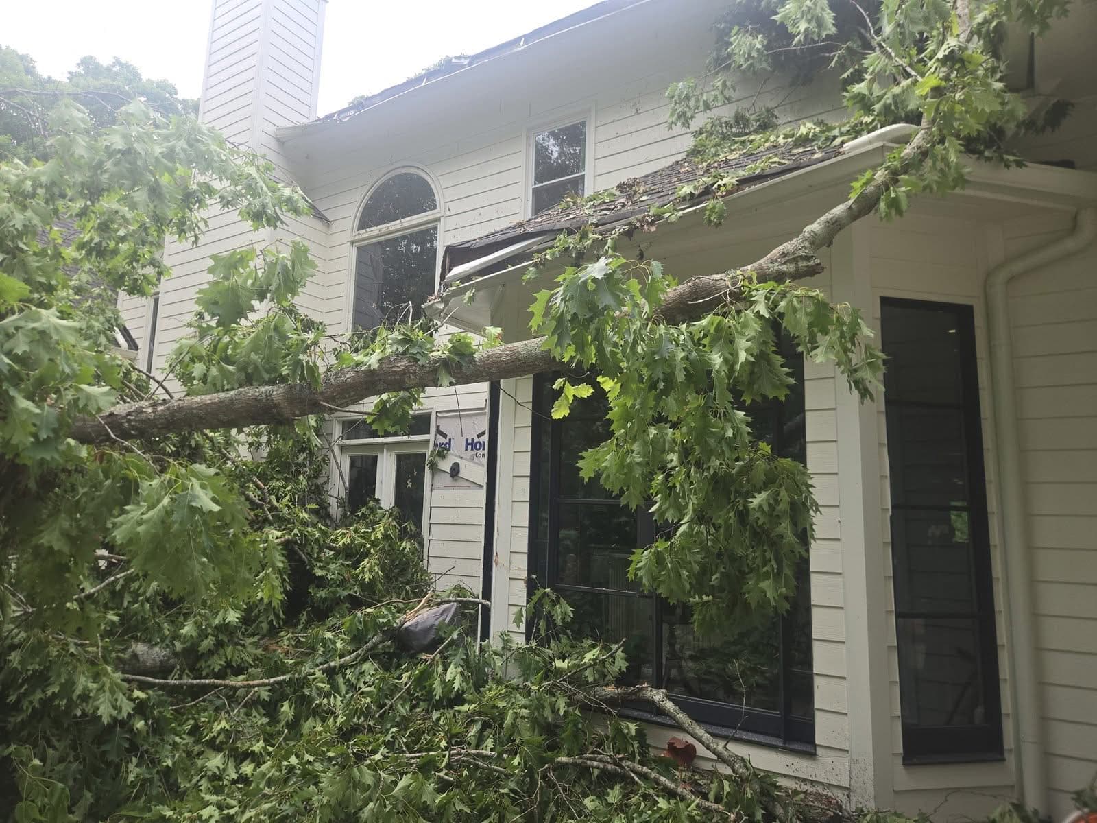 Large oak fallen onto the back of a house in Woodstock GA before removal, May 2026