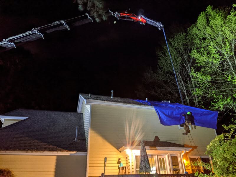 Emergency tree removal team in Atlanta responding to storm damage at night